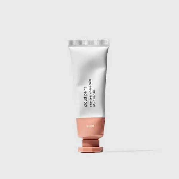 Glossier Cloud Paint in Dusk a neutral pink liquid blush. A fun no-makeup makeup product to put on your cheeks.
