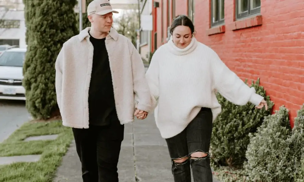 Couple walking wearing over-sized clothing.