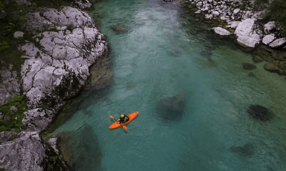 Man kayaking through lake. 