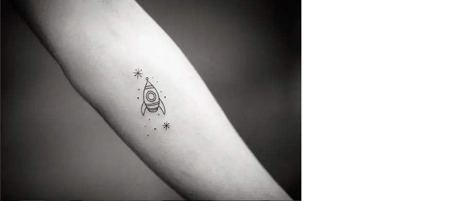 tattoo of a rocket ship with stars around