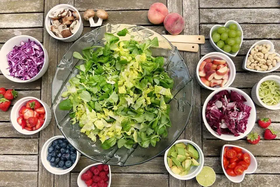 A bowl of salad with dressings and toppings surrounded by the bowl